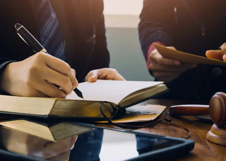 A person writing on a book
