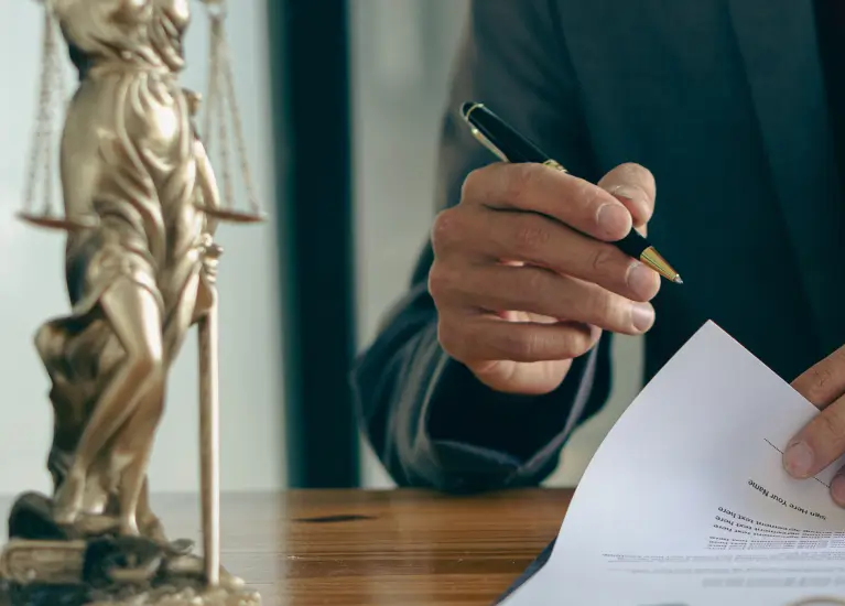 A man holding a pen and paper